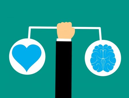 Arm holding out pictures of heart and brain