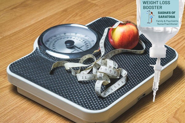 Weight loss - a scale with an apple and measuring tape on top