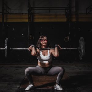 Woman squatting and lifting weights